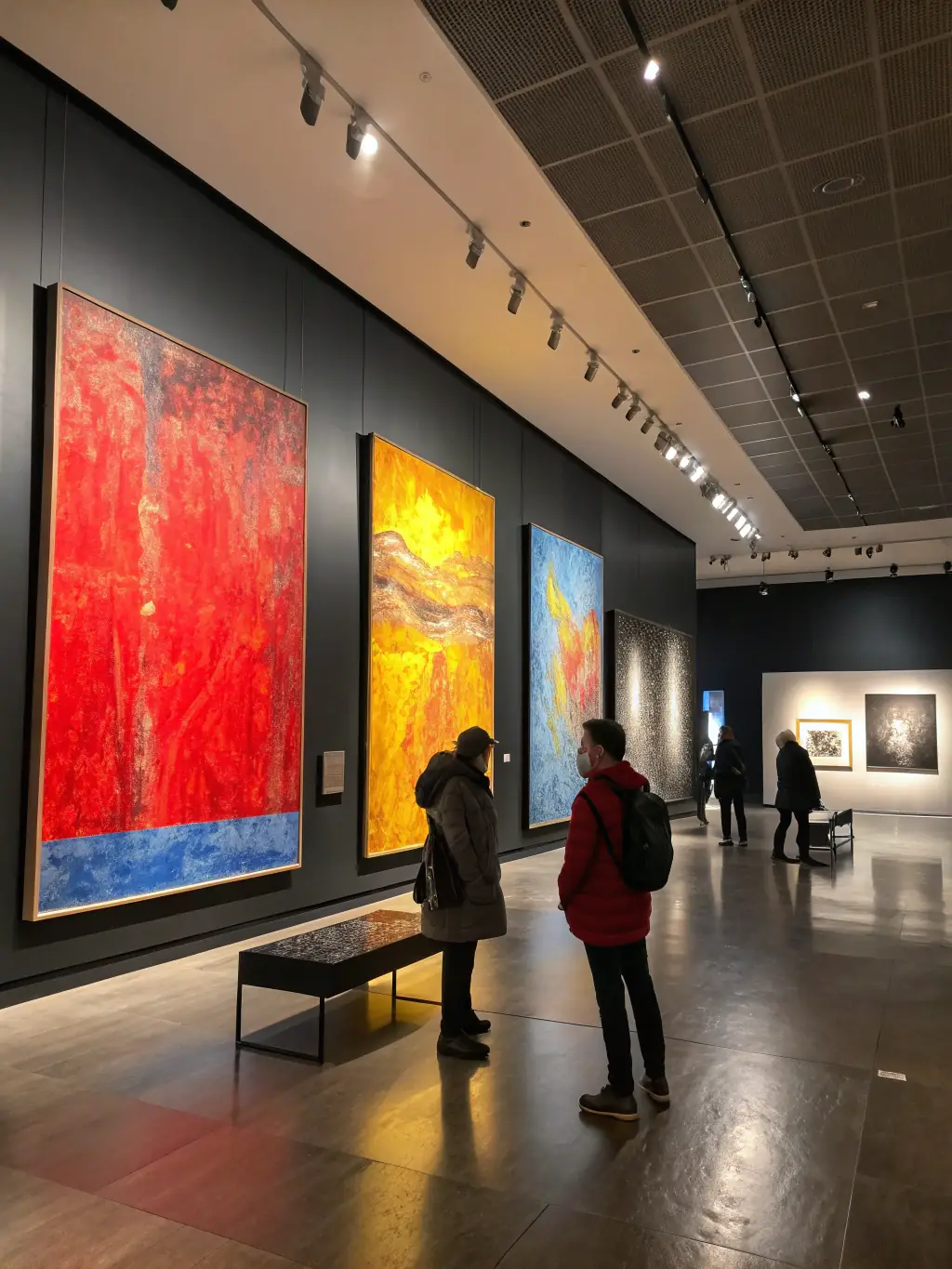 An image of an art exhibition supported by WILD MUSIC PROJECT, featuring diverse artworks and attendees appreciating the display.